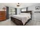 Relaxing main bedroom features wood furnishings, fan, neutral colors, and sliding glass door to the patio at 3612 Patina Dr, Tampa, FL 33619