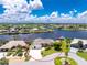 Stunning waterfront home featuring lush landscaping, a spacious driveway, and picturesque water views at 4142 Reif Ct, Port Charlotte, FL 33981