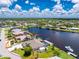 A beautiful waterfront home featuring a lush lawn, a pool, a private dock, and a shed at 4142 Reif Ct, Port Charlotte, FL 33981