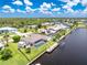 A captivating overhead shot of a waterside property, showcasing a private pool, personal dock, and flourishing green space at 4142 Reif Ct, Port Charlotte, FL 33981