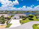 Stunning waterfront home featuring lush landscaping, a spacious driveway, and picturesque water views at 4142 Reif Ct, Port Charlotte, FL 33981