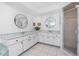Bright bathroom features white cabinetry, dual sinks, and glass shower at 4142 Reif Ct, Port Charlotte, FL 33981