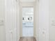 Hallway view into the ensuite bathroom with dual sinks and white cabinets at 4142 Reif Ct, Port Charlotte, FL 33981
