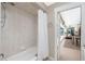 Tiled shower and bathtub with doorway leading to another room at 4142 Reif Ct, Port Charlotte, FL 33981