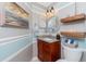 Stylish bathroom vanity with granite countertop, pendant lights, and floating wooden shelves at 4142 Reif Ct, Port Charlotte, FL 33981
