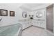 Bright bathroom features a soaking tub, white cabinetry, and glass shower at 4142 Reif Ct, Port Charlotte, FL 33981
