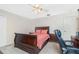 Well-lit bedroom showcases a charming wooden bed frame, cozy carpet, and classic ceiling fan at 4142 Reif Ct, Port Charlotte, FL 33981
