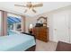 Cozy bedroom featuring a ceiling fan and sliding glass doors with a pool view at 4142 Reif Ct, Port Charlotte, FL 33981