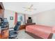 Comfortable bedroom with a ceiling fan, wood furnishings, and a large window for natural light at 4142 Reif Ct, Port Charlotte, FL 33981