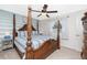 Bright bedroom features a unique four-poster bed, soft carpeting, and airy curtains at 4142 Reif Ct, Port Charlotte, FL 33981