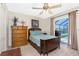 Cozy bedroom featuring a ceiling fan and sliding glass doors with a pool view at 4142 Reif Ct, Port Charlotte, FL 33981