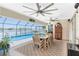 This dining area features a large table, ceiling fans, and views of the pool and waterfront at 4142 Reif Ct, Port Charlotte, FL 33981