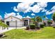 Charming single-story home features a well-manicured lawn, mature landscaping, and a convenient two-car garage at 4142 Reif Ct, Port Charlotte, FL 33981
