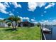 A scenic view with a well-maintained lawn leading to the canal and private dock at 4142 Reif Ct, Port Charlotte, FL 33981