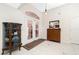 Bright and open foyer features tile floors, double doors, and elegant furnishings, offering a welcoming entrance to the home at 4142 Reif Ct, Port Charlotte, FL 33981