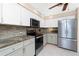 Updated kitchen with stainless steel appliances and stylish backsplash at 4142 Reif Ct, Port Charlotte, FL 33981
