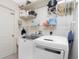 Practical laundry room with shelving, washer, and dryer at 4142 Reif Ct, Port Charlotte, FL 33981