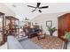 Spacious living area features tile flooring, a ceiling fan, and an open layout with views of the pool and outdoor living space at 4142 Reif Ct, Port Charlotte, FL 33981