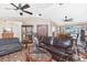 Bright and airy living area features a ceiling fan, tile floors, and seamless access to the dining area and outdoor pool at 4142 Reif Ct, Port Charlotte, FL 33981