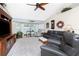 Cozy living room with vaulted ceilings, large windows, ceiling fan and comfortable seating at 4142 Reif Ct, Port Charlotte, FL 33981