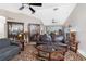 Cozy living room with vaulted ceilings, ceiling fan, display cases, and elegant furnishings at 4142 Reif Ct, Port Charlotte, FL 33981