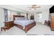 Spacious main bedroom with ceiling fan, dark wood furnishings and lots of natural light at 4142 Reif Ct, Port Charlotte, FL 33981