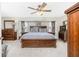 Spacious main bedroom with dark wood furnishings, ceiling fan and lots of natural light at 4142 Reif Ct, Port Charlotte, FL 33981