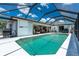 A screened-in pool with a canal view is nestled among the exterior and interior living spaces at 4142 Reif Ct, Port Charlotte, FL 33981
