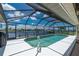 A screened-in pool overlooks the canal, offering a refreshing escape with waterfront views at 4142 Reif Ct, Port Charlotte, FL 33981