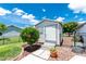 White shed and hibiscus tree with landscaping and walkway at 4142 Reif Ct, Port Charlotte, FL 33981
