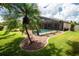 A backyard view showing a beautiful pool, lush landscaping, and privacy at 4640 W Price Blvd, North Port, FL 34286