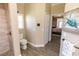 Bathroom showcasing shower, toilet, and doorway to bedroom at 4640 W Price Blvd, North Port, FL 34286