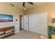 Bright bedroom with closet, ceiling fan, and an artful dresser against tan walls at 4640 W Price Blvd, North Port, FL 34286