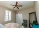 Bedroom featuring ceiling fan, window with shutters, mirror, chair, and closet at 4640 W Price Blvd, North Port, FL 34286