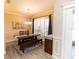 Elegant dining room with a large window, wood table, and modern chandelier at 4640 W Price Blvd, North Port, FL 34286
