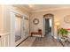 Inviting entryway with stylish decor, arched doorway, and wood-look tile flooring at 4640 W Price Blvd, North Port, FL 34286