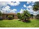 A charming home exterior features a lush lawn, mature palms, and lovely landscaping creating curb appeal at 4640 W Price Blvd, North Port, FL 34286