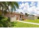 Exterior backyard with a well-maintained yard, fence, and mature landscaping at 4640 W Price Blvd, North Port, FL 34286