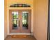 Welcoming double front doors with a 'HELLO' mat and charming decorative accents at 4640 W Price Blvd, North Port, FL 34286