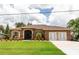 Charming single Gathering home features a beautifully landscaped yard and stone accents on the facade at 4640 W Price Blvd, North Port, FL 34286