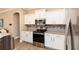 The kitchen has stainless steel appliances, white cabinetry, granite countertops, and a tile backsplash at 4640 W Price Blvd, North Port, FL 34286
