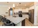 Modern kitchen featuring white cabinets, stainless steel appliances, and a granite island with seating at 4640 W Price Blvd, North Port, FL 34286
