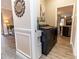 Laundry area with modern appliances and wood-look flooring near the home's interior at 4640 W Price Blvd, North Port, FL 34286