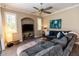 The living room has wood-look tile flooring, an accent wall alcove with TV, and a large comfy sofa at 4640 W Price Blvd, North Port, FL 34286