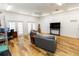 Living room features hardwood floors, neutral furniture, desk, and natural light at 4640 W Price Blvd, North Port, FL 34286