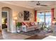 Comfortable living room with a sofa, accent pillows, and a view to the patio at 4640 W Price Blvd, North Port, FL 34286