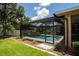 Screened-in pool area with a waterfall feature, providing a private outdoor oasis and a relaxing escape at 4640 W Price Blvd, North Port, FL 34286