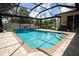 Sparkling pool with a screened enclosure and paved deck area for outdoor entertaining at 4640 W Price Blvd, North Port, FL 34286
