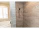 Detailed shower stall featuring updated tile surround, shower head, and bench at 4640 W Price Blvd, North Port, FL 34286