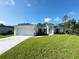 Charming single-story home with a well-manicured lawn, attached garage, and lovely architectural details at 4863 Las Almanos Ave, North Port, FL 34288